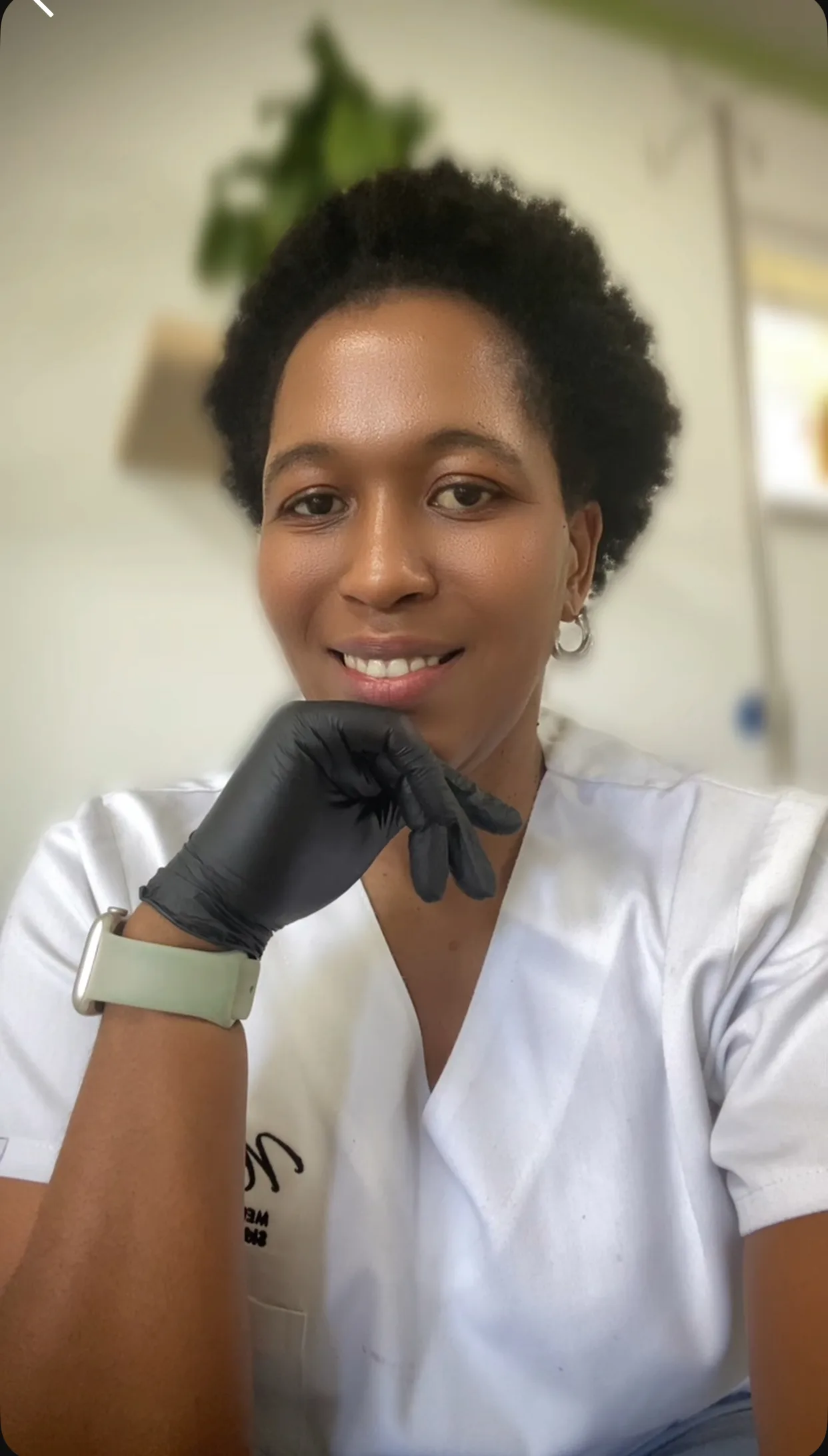 Dr. Nokwazi Ndlela in treatment scrubs with black nitrile gloves
